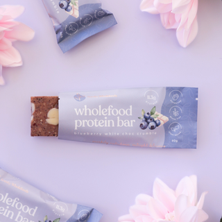 open blueberry crumble protein bar showing the white chocolate chips inside 