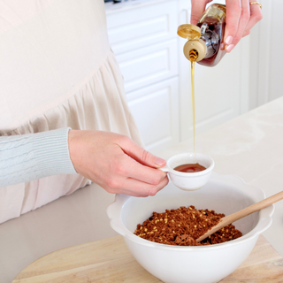 A bowl of Sneaky Wholefoods Choc Chip Honeycomb Protein Ball Mix, showcasing the golden honeycomb pieces and chocolate chips, being made for an easy 5-minute snack