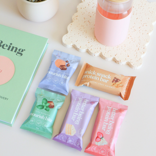 An assortment of Sneaky Wholefoods Protein Bars and Nourish Bites displayed together, showcasing delicious flavors designed to provide quick, nutritious snacks perfect for elevating snack time