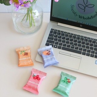 Variety of Sneaky Wholefoods Nourish Bites from The Office Bite Bundle arranged together, emphasizing their delicious flavors and wholesome ingredients, designed to keep energy levels high and staff motivated throughout the workday.