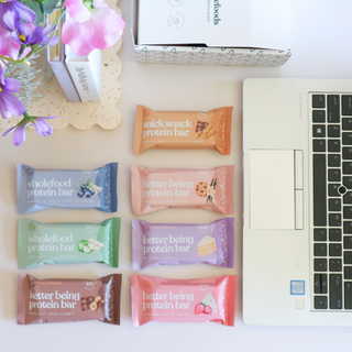 A collection of Sneaky Wholefoods Protein Bars from the Office Bar Bundle arranged in a bright office setting, ideal for mid-morning meetings and afternoon energy boosts to keep the team healthy and productive.