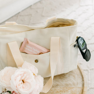 A Sneaky Wholefoods Vanilla Cookie Dough Protein Bar packed in a stylish handbag, ready for a busy workday, emphasizing convenience and delicious snacking on-the-go